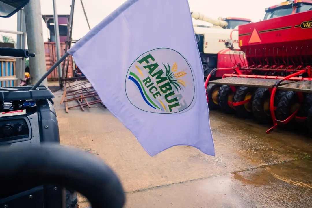 Fambul Rice flag beside agricultural machinery
