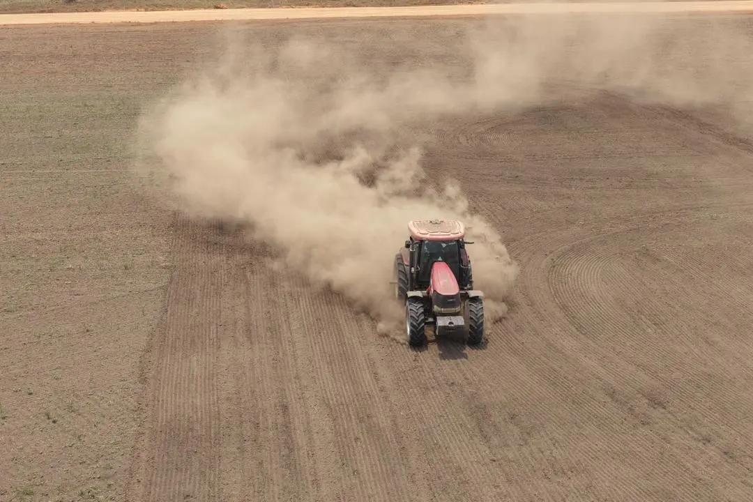 Tractor preparing a large Fambul Rice field